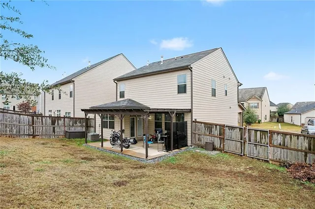 a backyard of a house with table and chairs