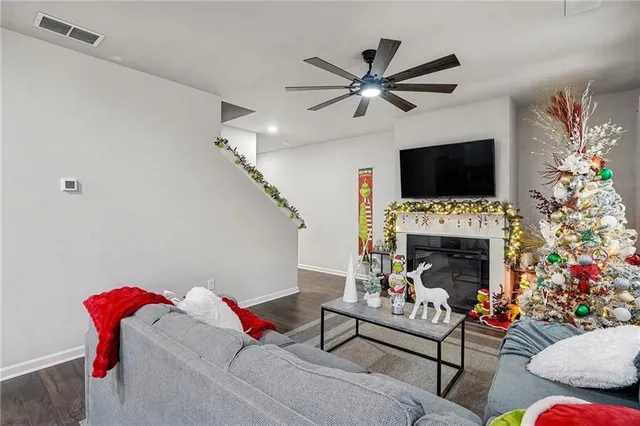 a living room with furniture a fireplace and a flat screen tv