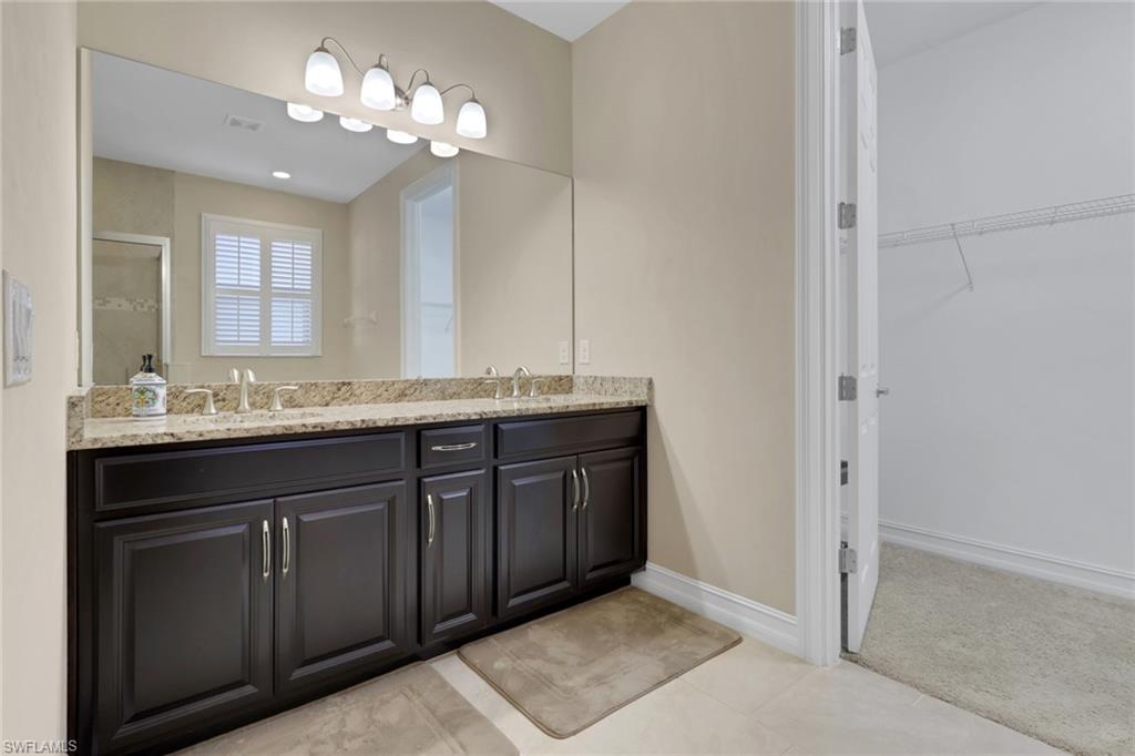 16309 Aberdeen Way Naples, FL 34110 - Photo 16 of 34 a bathroom with a granite countertop sink and a mirror
