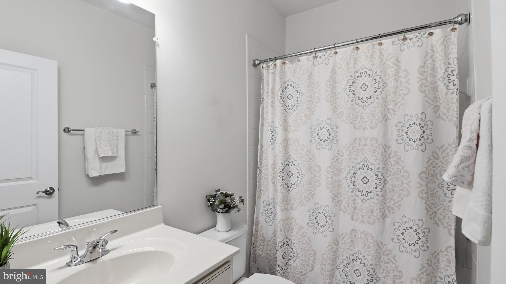 13806 Litespeed Way Gainesville, VA 20155 - Photo 13 of 22 a bathroom with a sink and a mirror