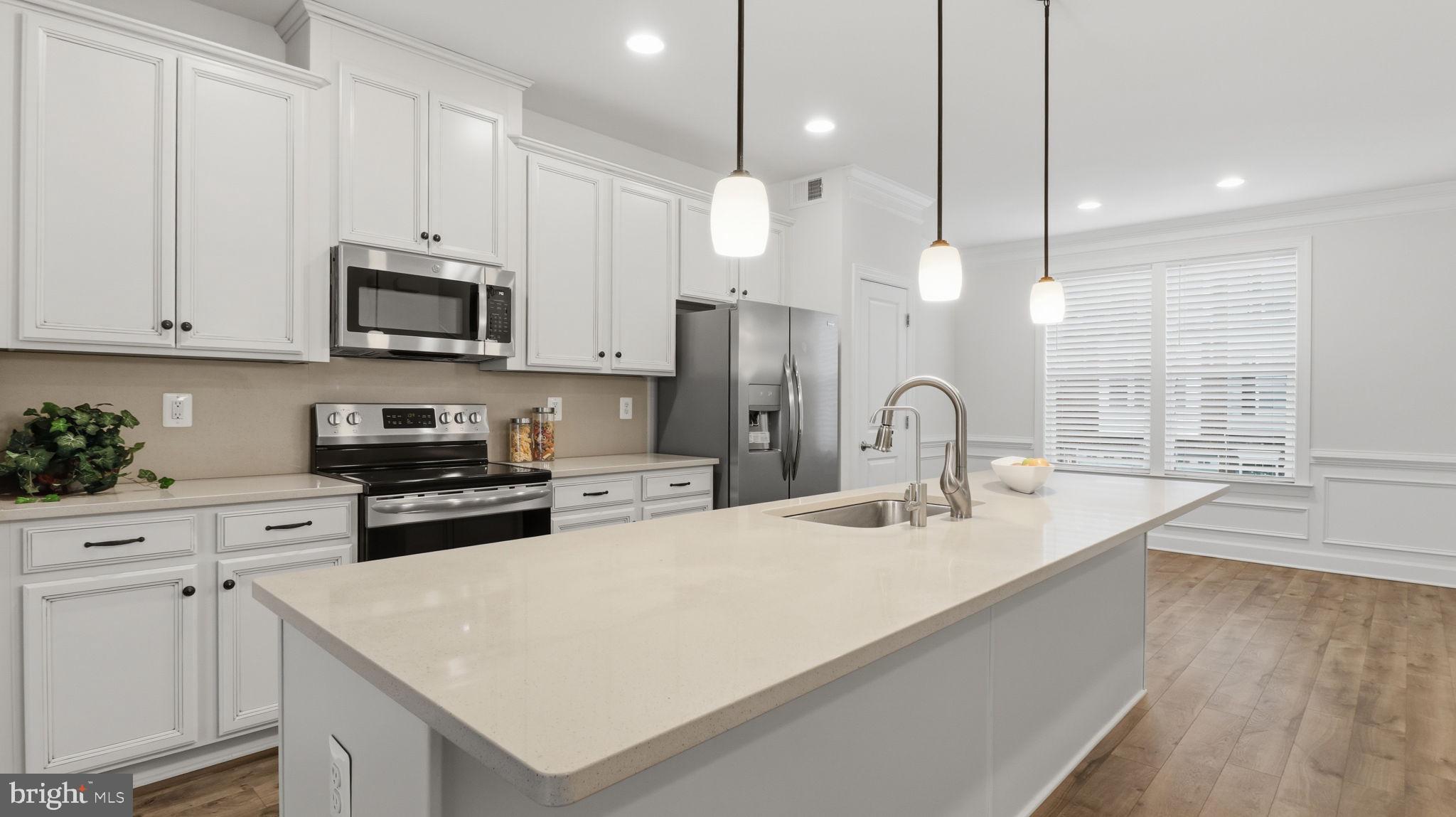 13806 Litespeed Way Gainesville, VA 20155 - Photo 16 of 22 a kitchen with stainless steel appliances granite countertop a sink a stove and a wooden floors