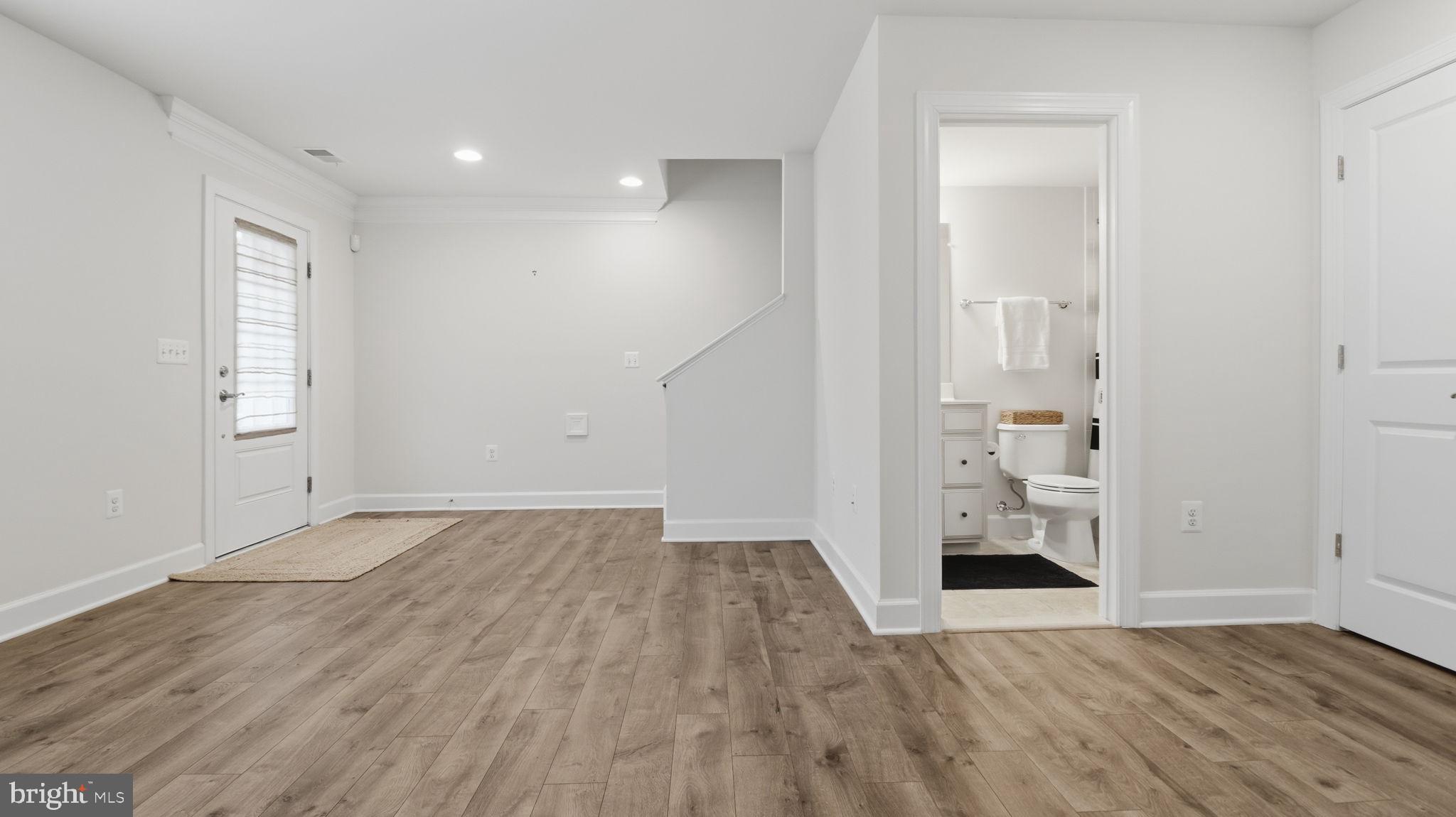 13806 Litespeed Way Gainesville, VA 20155 - Photo 19 of 22 an empty room with wooden floor and windows