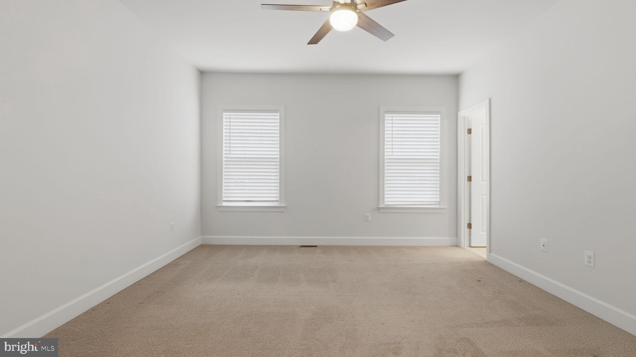 13806 Litespeed Way Gainesville, VA 20155 - Photo 7 of 22 an empty room with windows and fan
