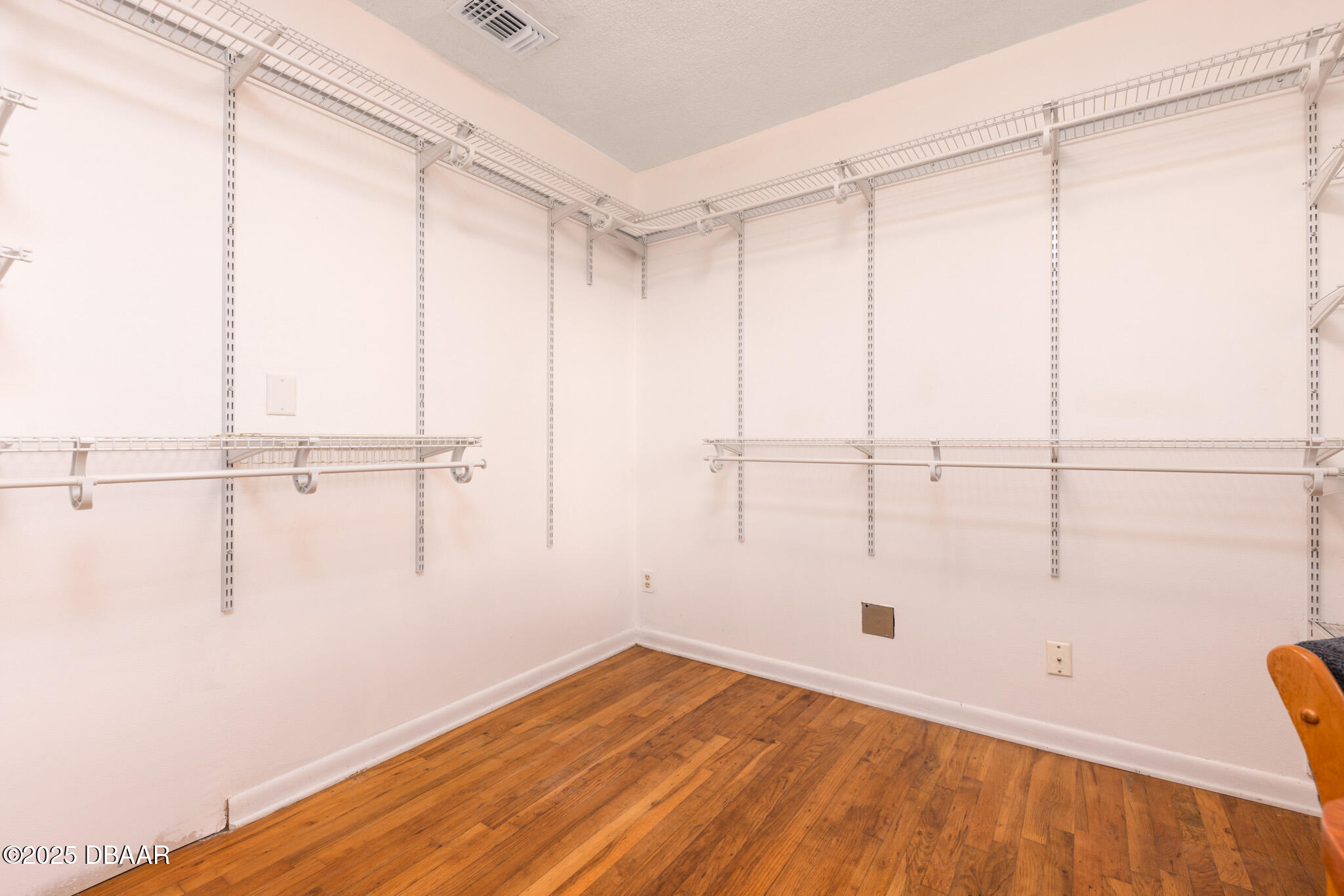 7915 Breezy Point Road East, Unit W Melrose, FL 32666 - Photo 11 of 36 a view of a room with wooden floor