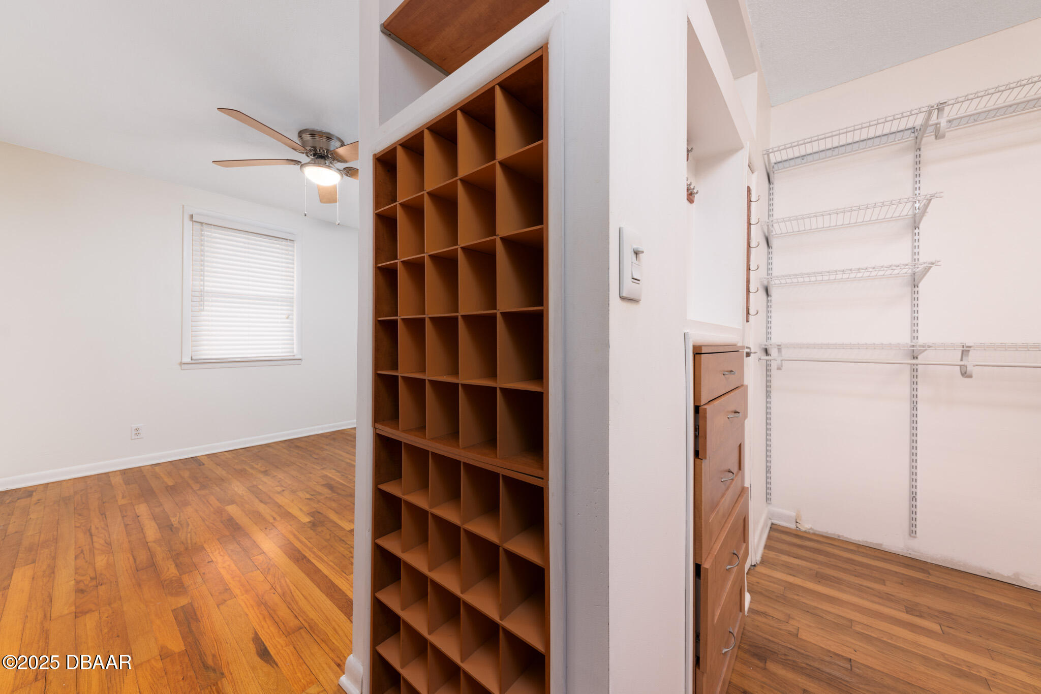 7915 Breezy Point Road East, Unit W Melrose, FL 32666 - Photo 14 of 36 a view of walk in closet with empty racks