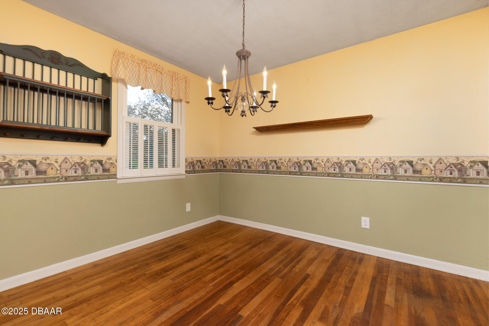 7915 Breezy Point Road East, Unit W Melrose, FL 32666 - Photo 18 of 36 a view of a room with wooden floor and chandelier