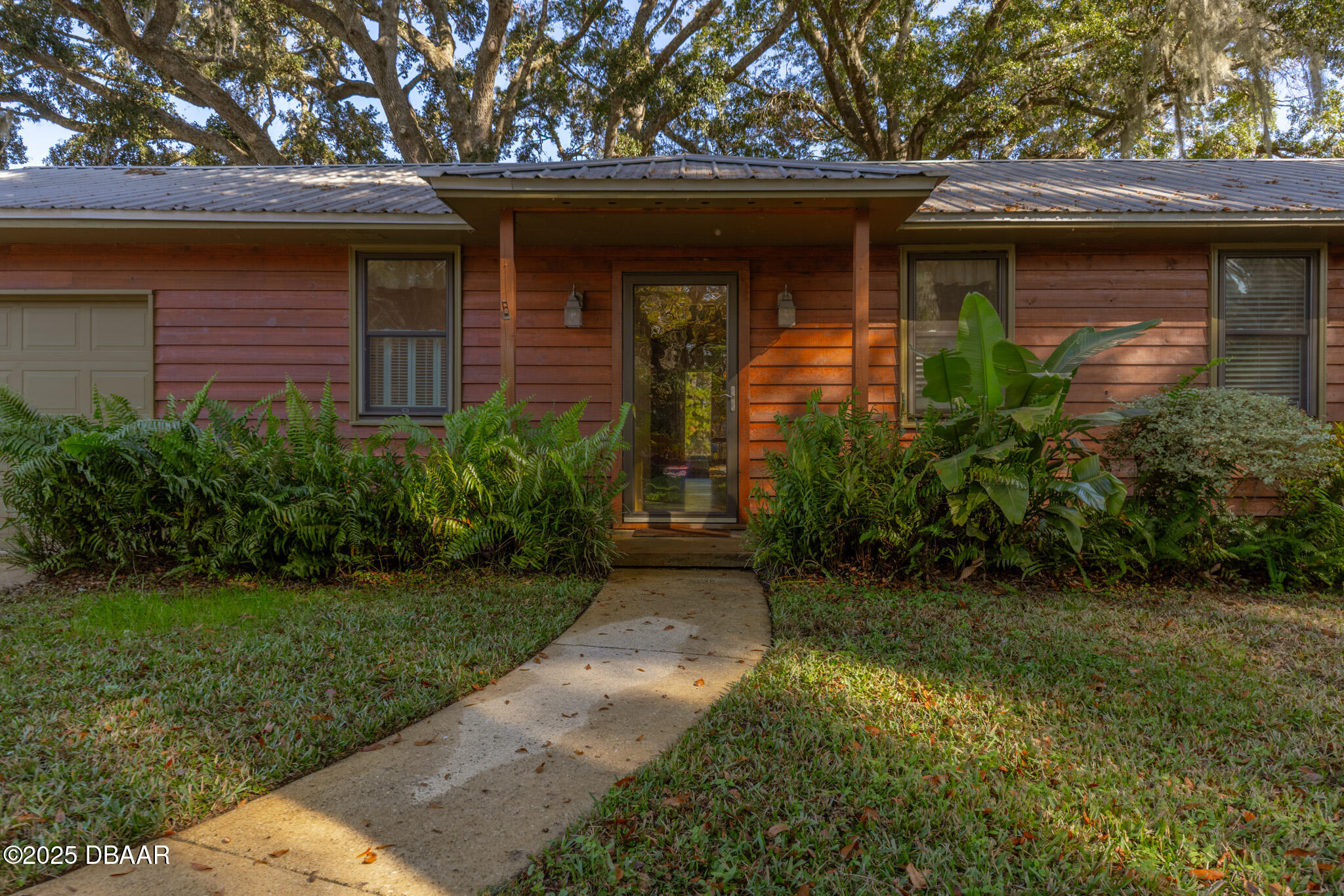 7915 Breezy Point Road East, Unit W Melrose, FL 32666 - Photo 20 of 36 a front view of a house with garden