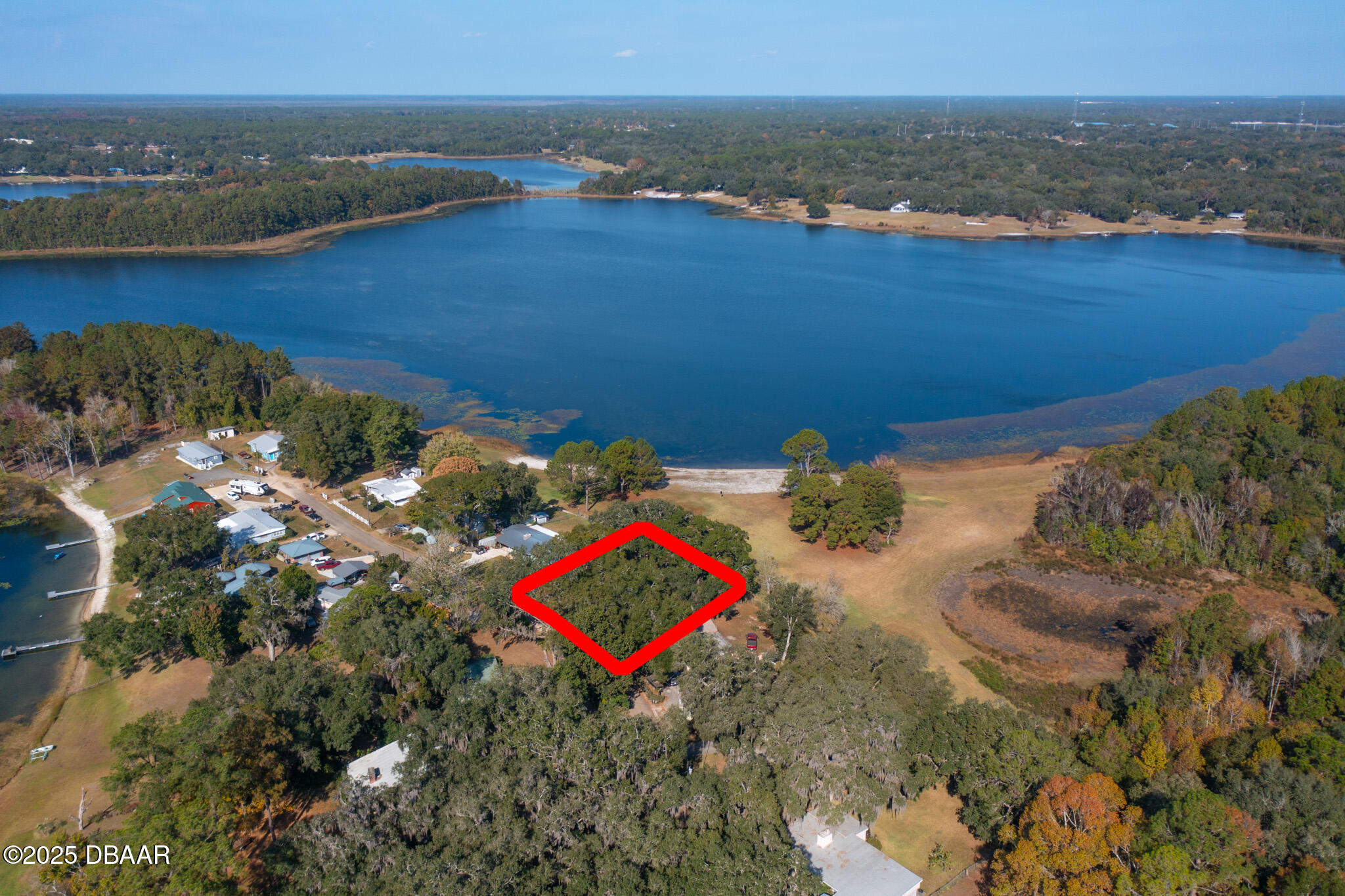 7915 Breezy Point Road East, Unit W Melrose, FL 32666 - Photo 2 of 36 an aerial view of a house with a yard