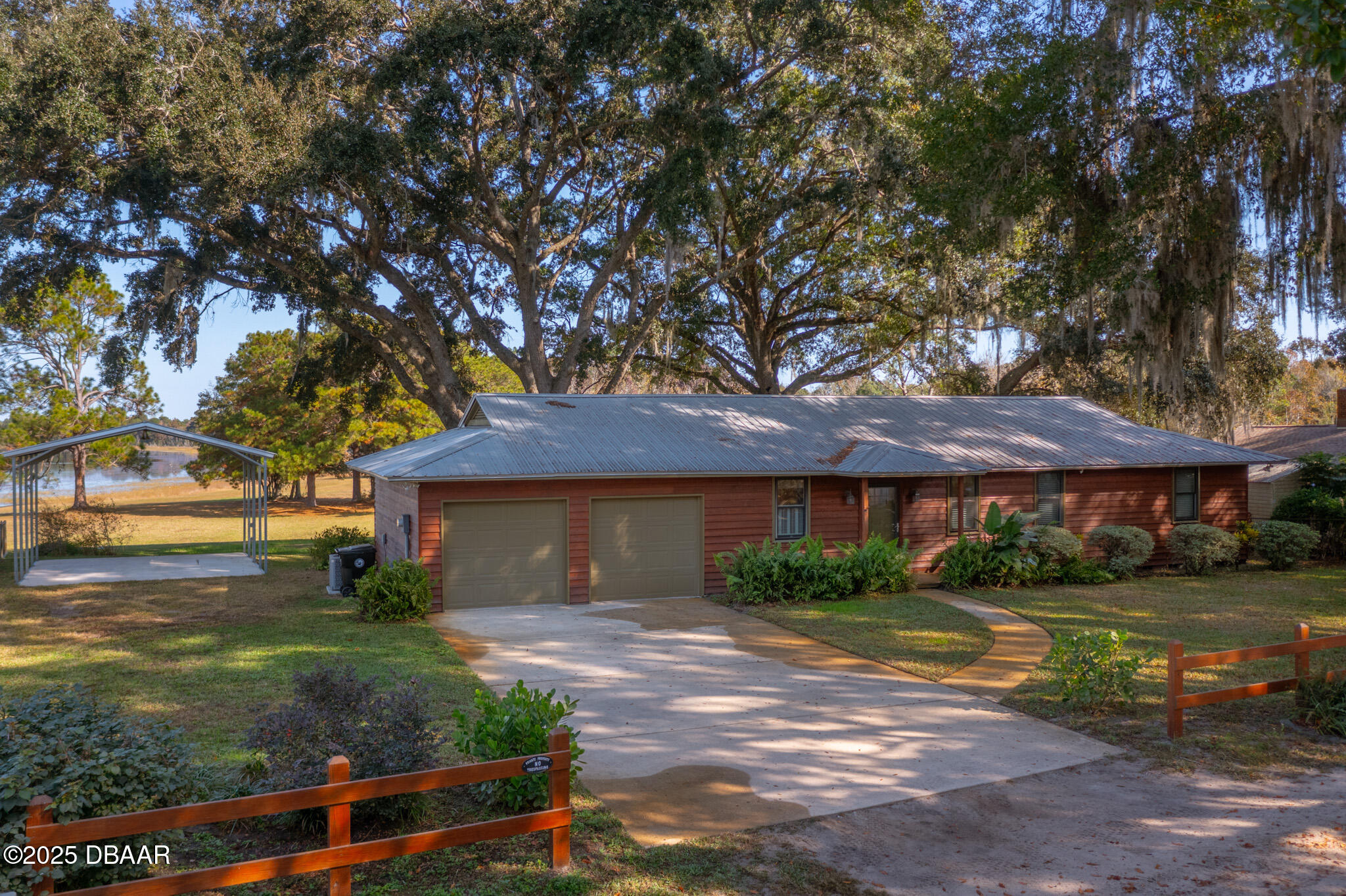7915 Breezy Point Road East, Unit W Melrose, FL 32666 - Photo 21 of 36 a front view of a house with garden