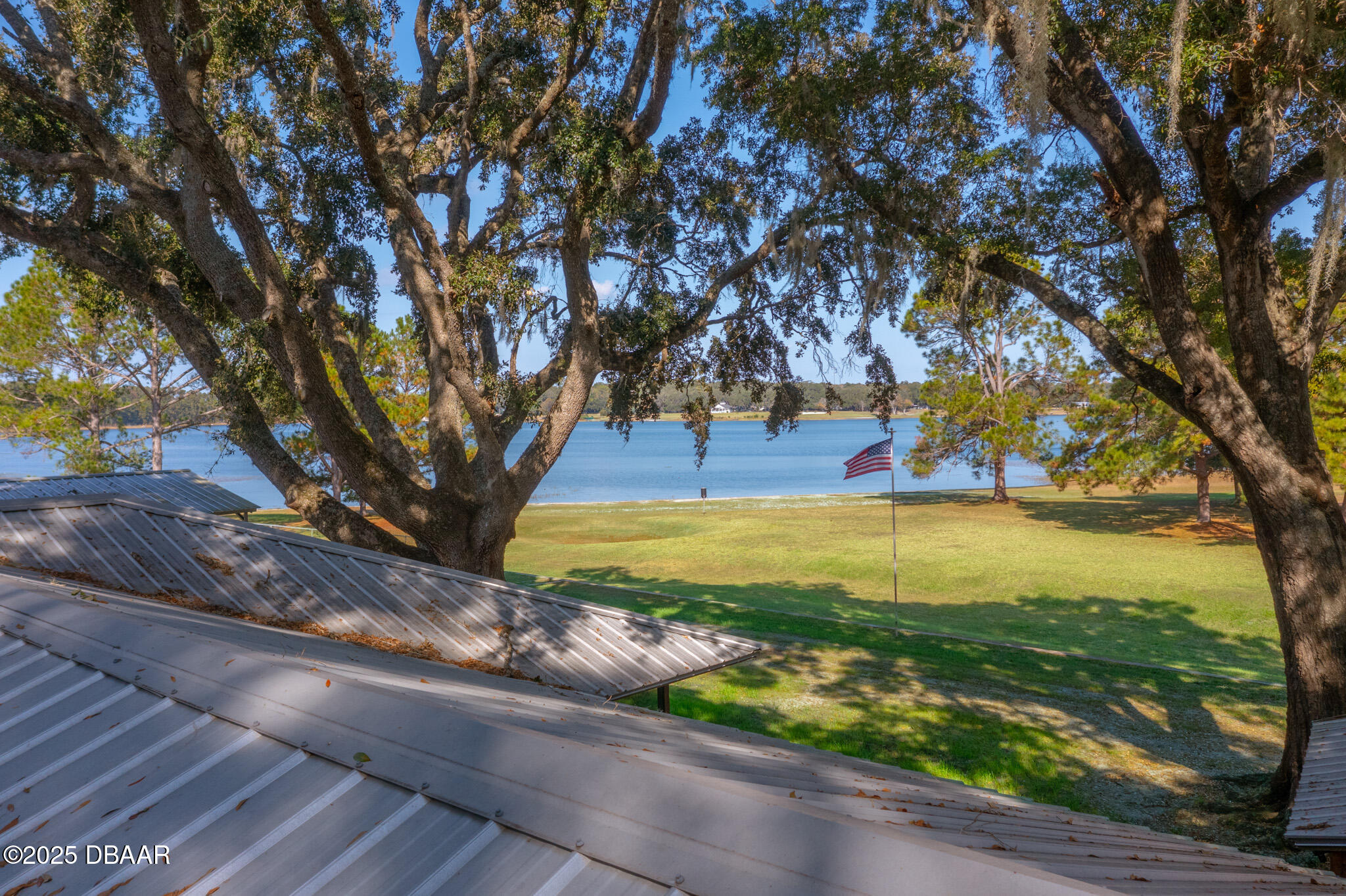 7915 Breezy Point Road East, Unit W Melrose, FL 32666 - Photo 29 of 36 a view of a yard with an umbrella