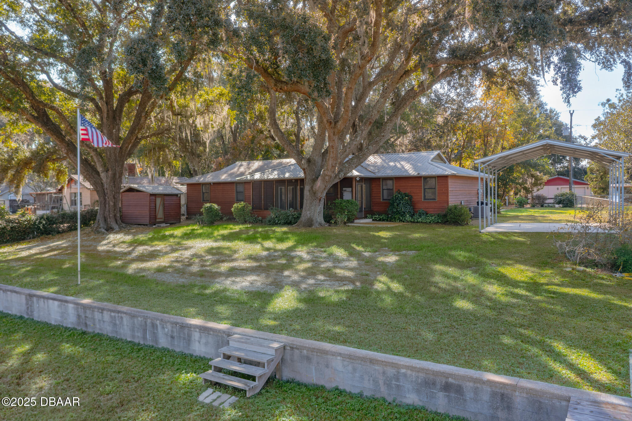 7915 Breezy Point Road East, Unit W Melrose, FL 32666 - Photo 3 of 36 a view of a house with a yard