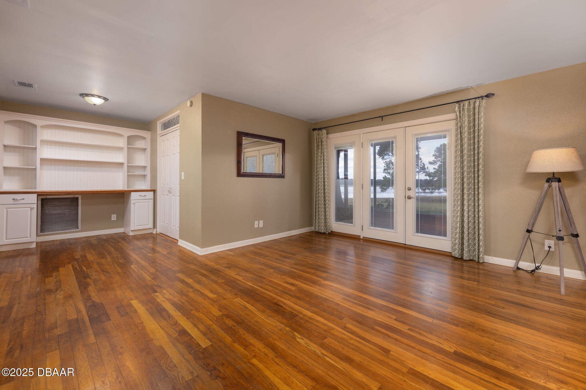 7915 Breezy Point Road East, Unit W Melrose, FL 32666 - Photo 34 of 36 a view of empty room with wooden floor and fireplace