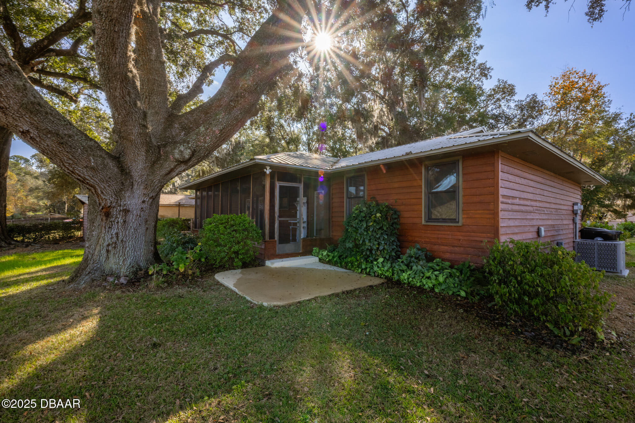 7915 Breezy Point Road East, Unit W Melrose, FL 32666 - Photo 4 of 36 a view of a house with a yard and tree s