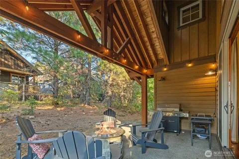 a backyard of a house with table and chairs