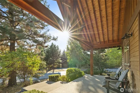 a view of a patio with table and chairs and wooden fence