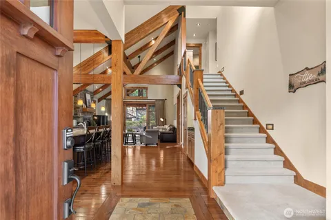 a view of entryway and hall with wooden floor