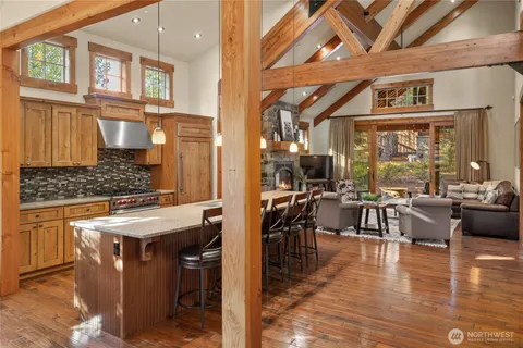 a view of a dining hall with couches a dining table and chairs with wooden floors