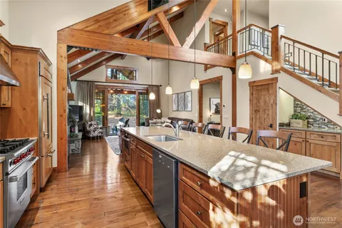 a large white kitchen with a large window