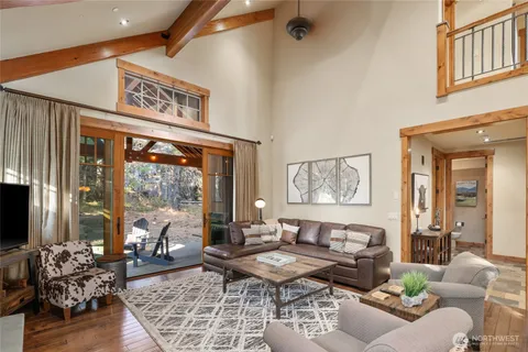 a living room with furniture and large windows