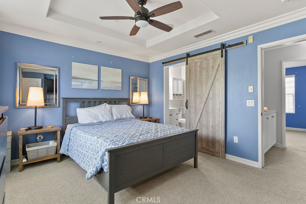 18 Triad Lane Ladera Ranch, CA 92694 - Photo 17 of 37 a bedroom with a bed and a chandelier