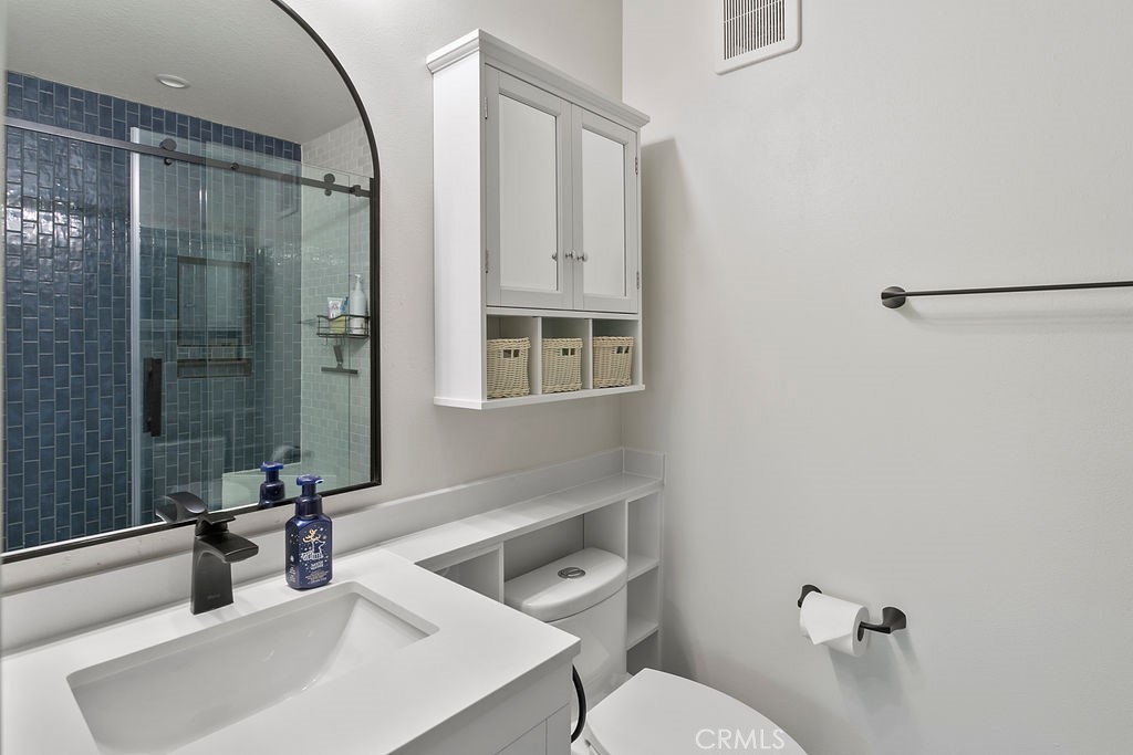 18 Triad Lane Ladera Ranch, CA 92694 - Photo 19 of 37 a bathroom with a sink mirror toilet and shower