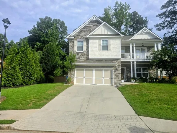 a front view of a house with a garden