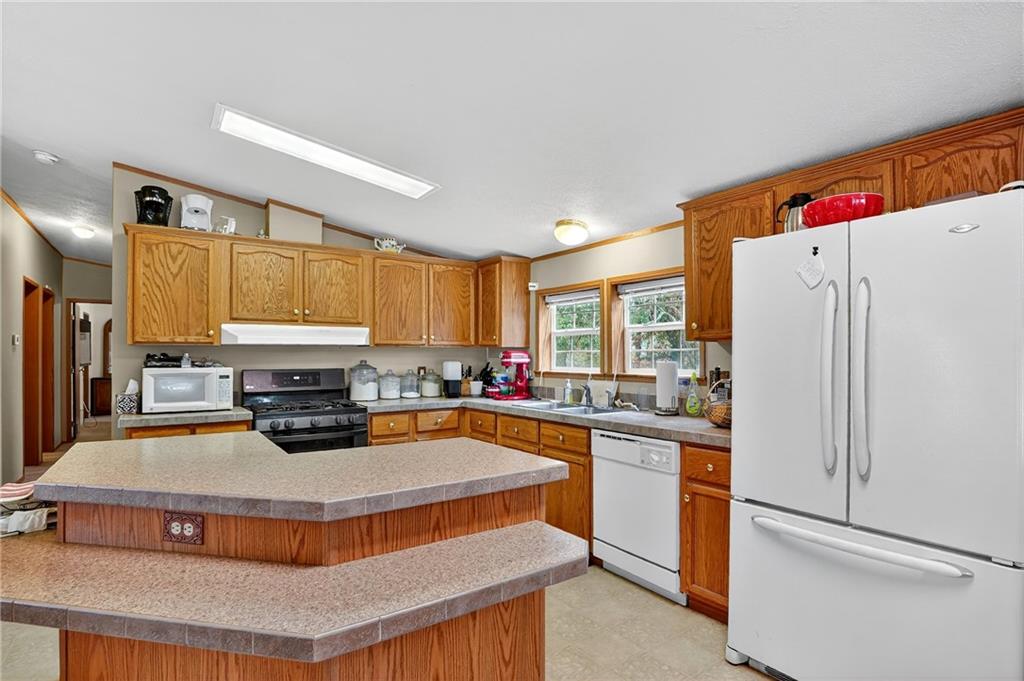332 Overbrook Road Valencia, PA 16059 - Photo 39 of 50 a kitchen with stainless steel appliances a stove refrigerator sink and cabinets