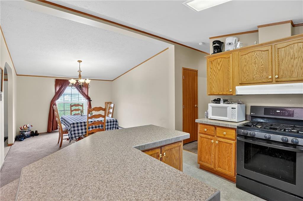 332 Overbrook Road Valencia, PA 16059 - Photo 40 of 50 a kitchen with stainless steel appliances granite countertop a stove a sink and a refrigerator