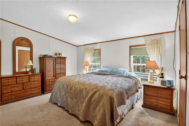 a bathroom with a sink toilet a mirror and shower