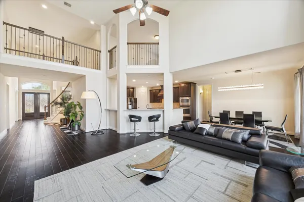 a living room with furniture and wooden floor