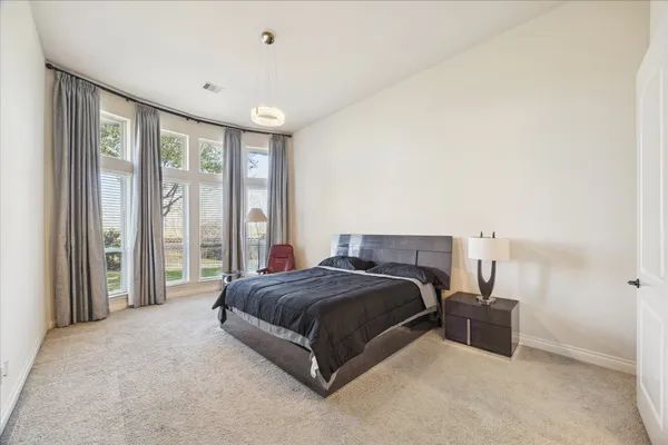 a bedroom with a bed and large window