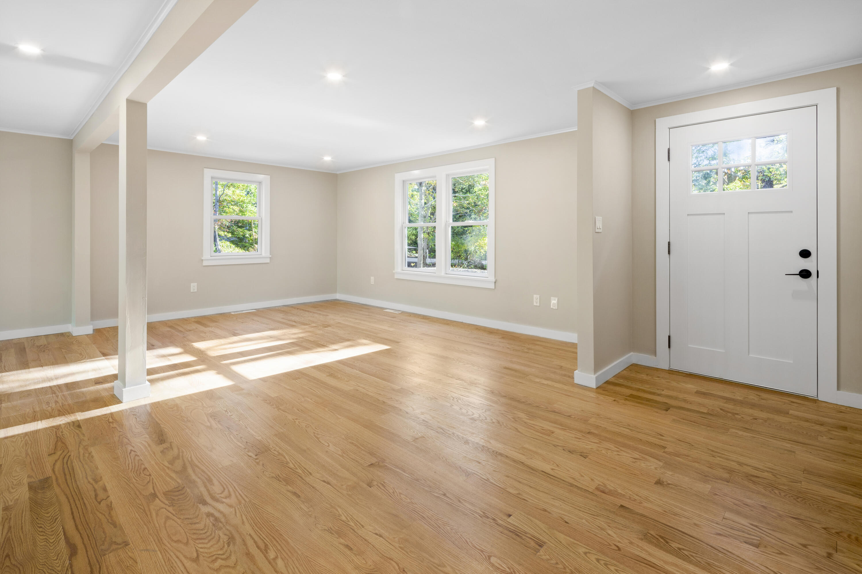 145 Stony Brook Road Brewster, MA 02631 - Photo 12 of 42 an empty room with wooden floor and windows