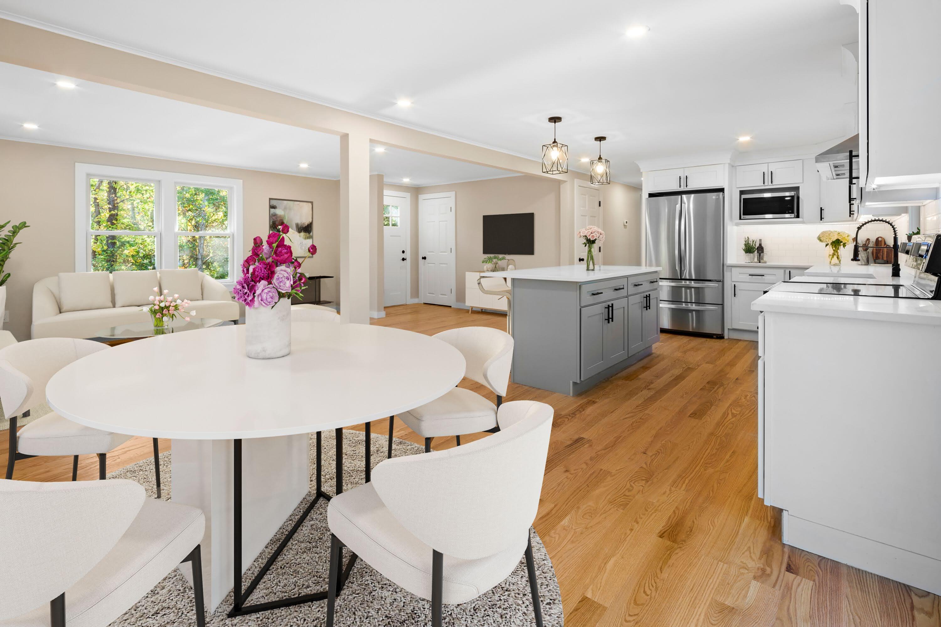 145 Stony Brook Road Brewster, MA 02631 - Photo 19 of 42 a large kitchen with cabinets a sink dishwasher a dining table and chairs with wooden floor