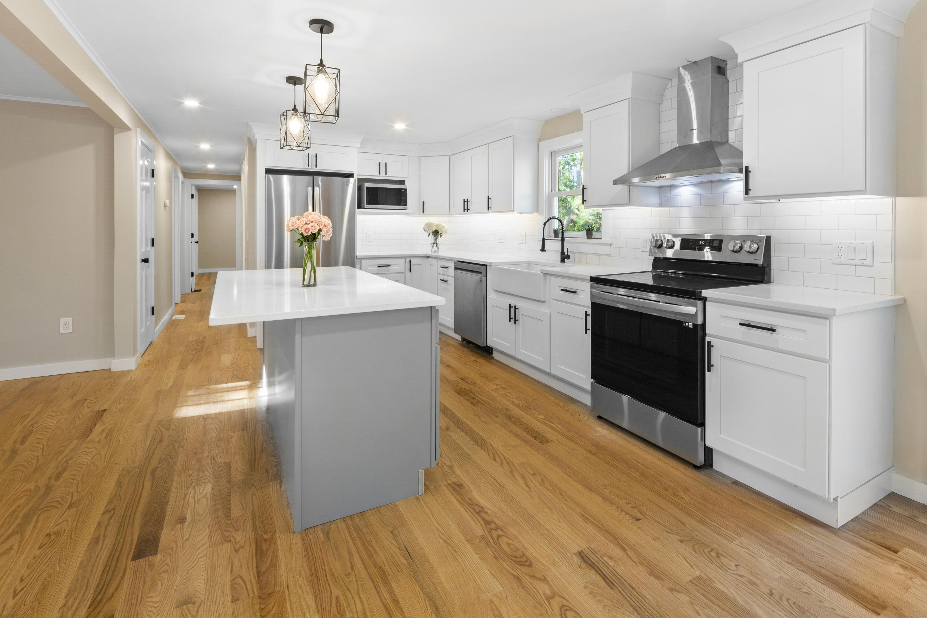 145 Stony Brook Road Brewster, MA 02631 - Photo 21 of 42 a large kitchen with stainless steel appliances granite countertop a lot of counter space and wooden floors