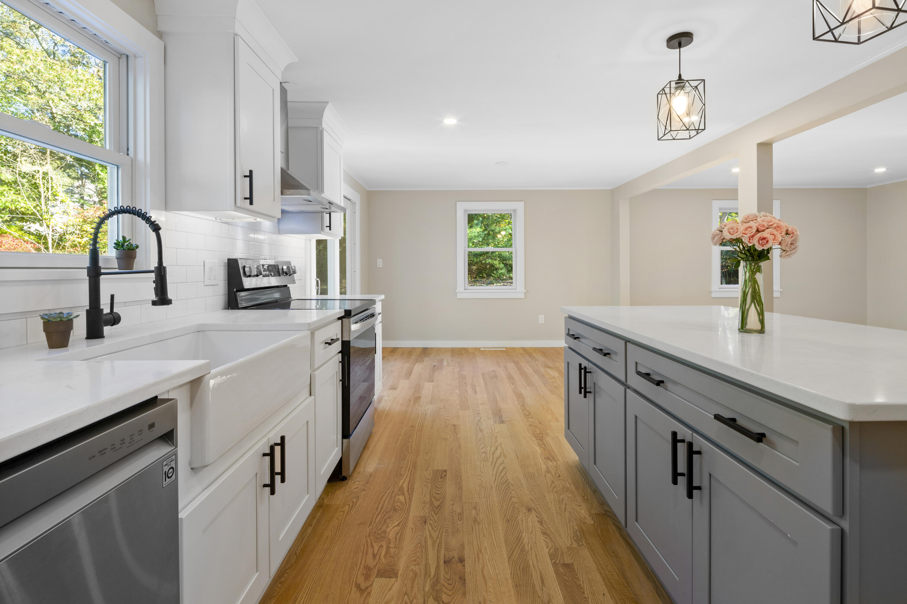 145 Stony Brook Road Brewster, MA 02631 - Photo 23 of 42 a kitchen with stainless steel appliances a sink dishwasher a stove a sink dishwasher and a stove with wooden floor