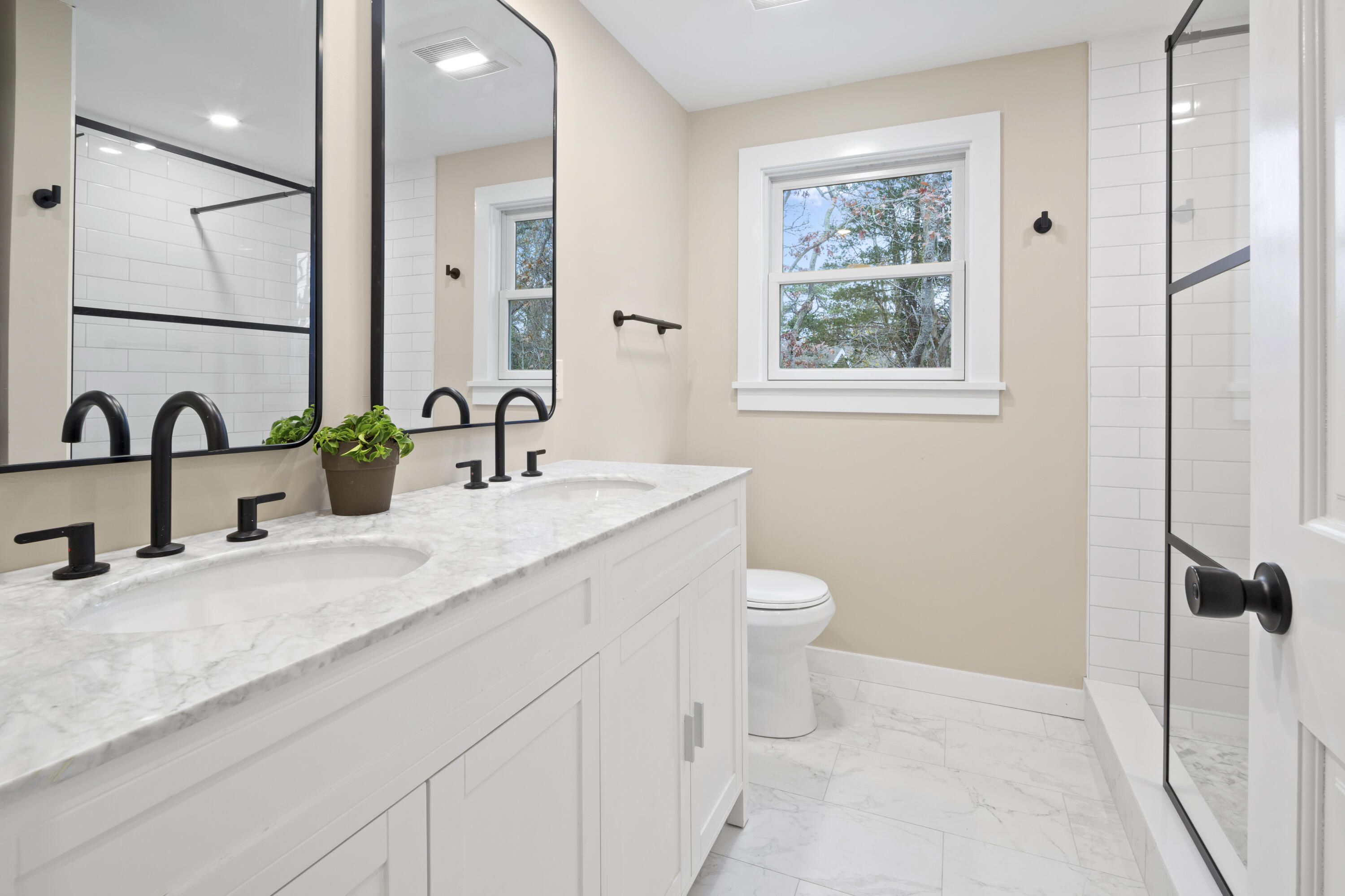145 Stony Brook Road Brewster, MA 02631 - Photo 25 of 42 a bathroom with a double vanity sink toilet and a mirror