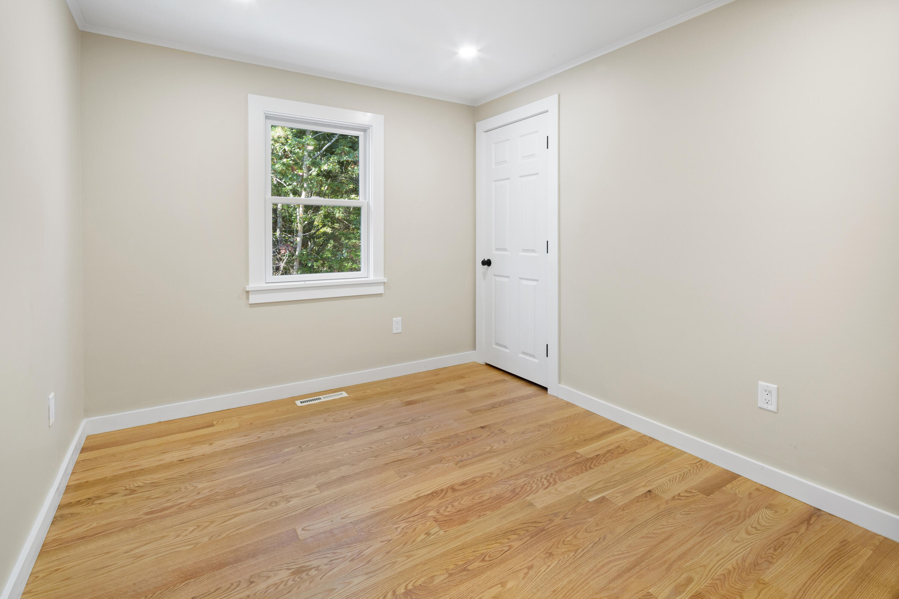 145 Stony Brook Road Brewster, MA 02631 - Photo 29 of 42 an empty room with wooden floor and a window