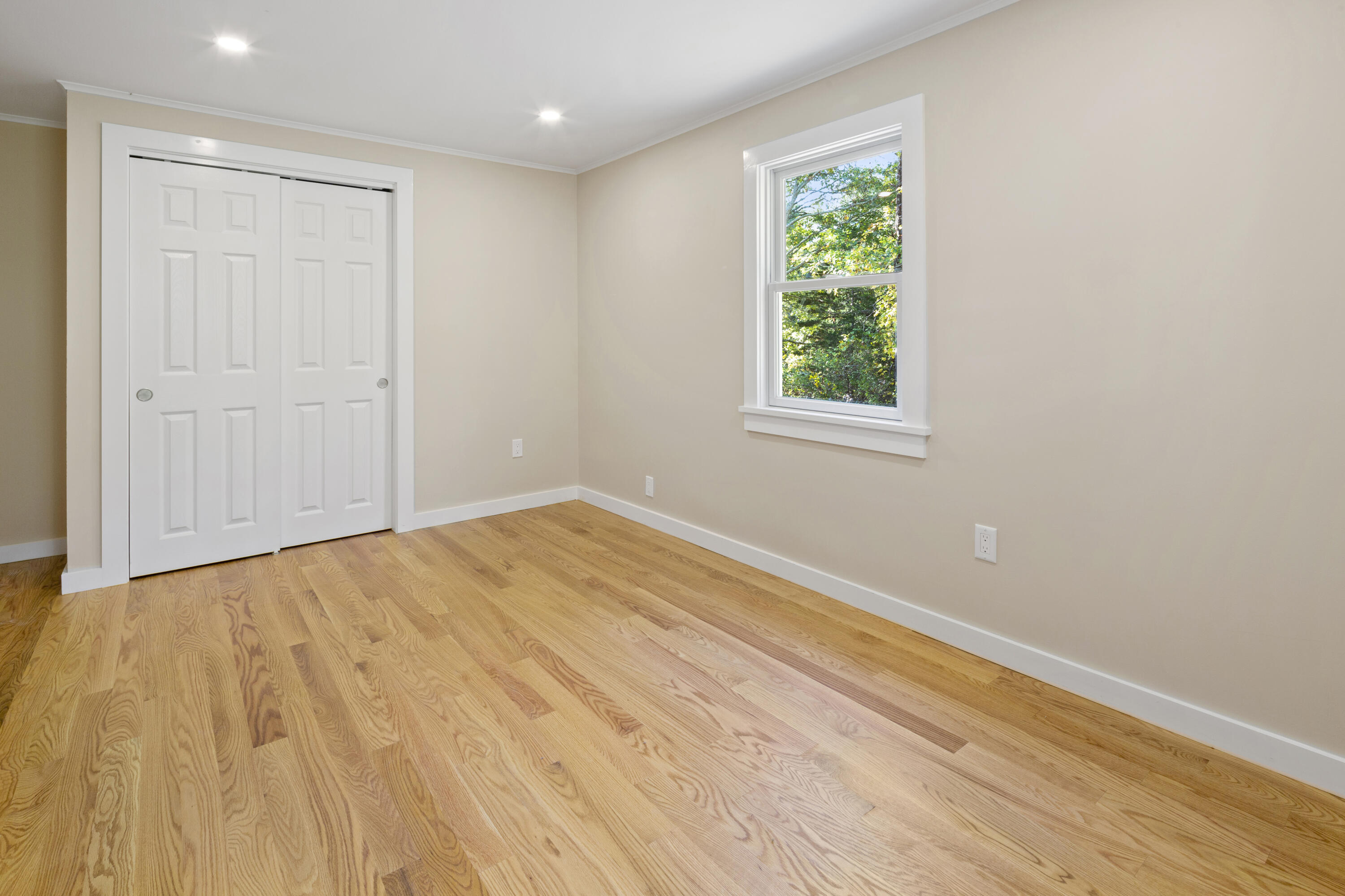 145 Stony Brook Road Brewster, MA 02631 - Photo 33 of 42 a view of an empty room with wooden floor and a window
