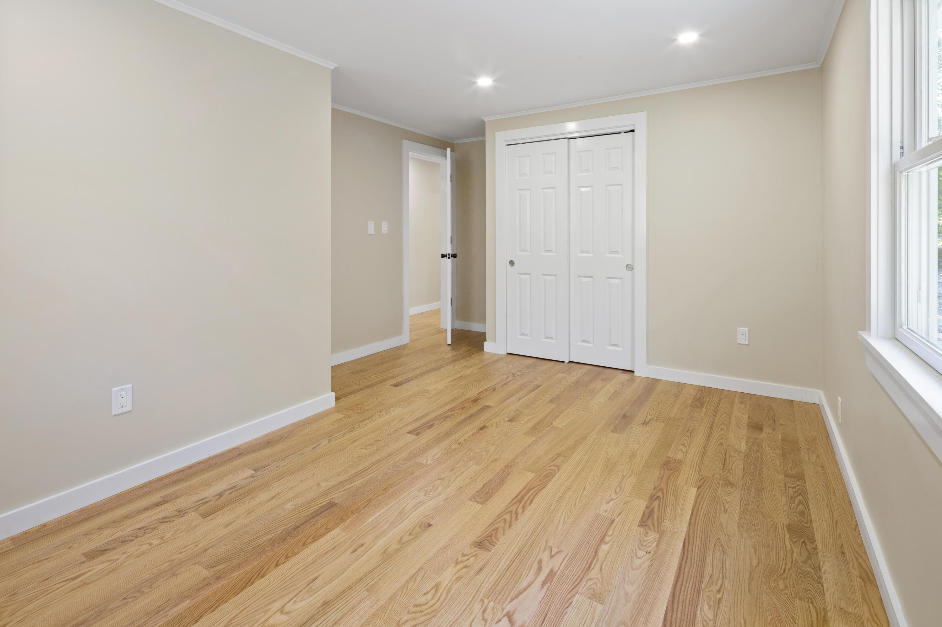 145 Stony Brook Road Brewster, MA 02631 - Photo 34 of 42 wooden floor in an empty room with a window