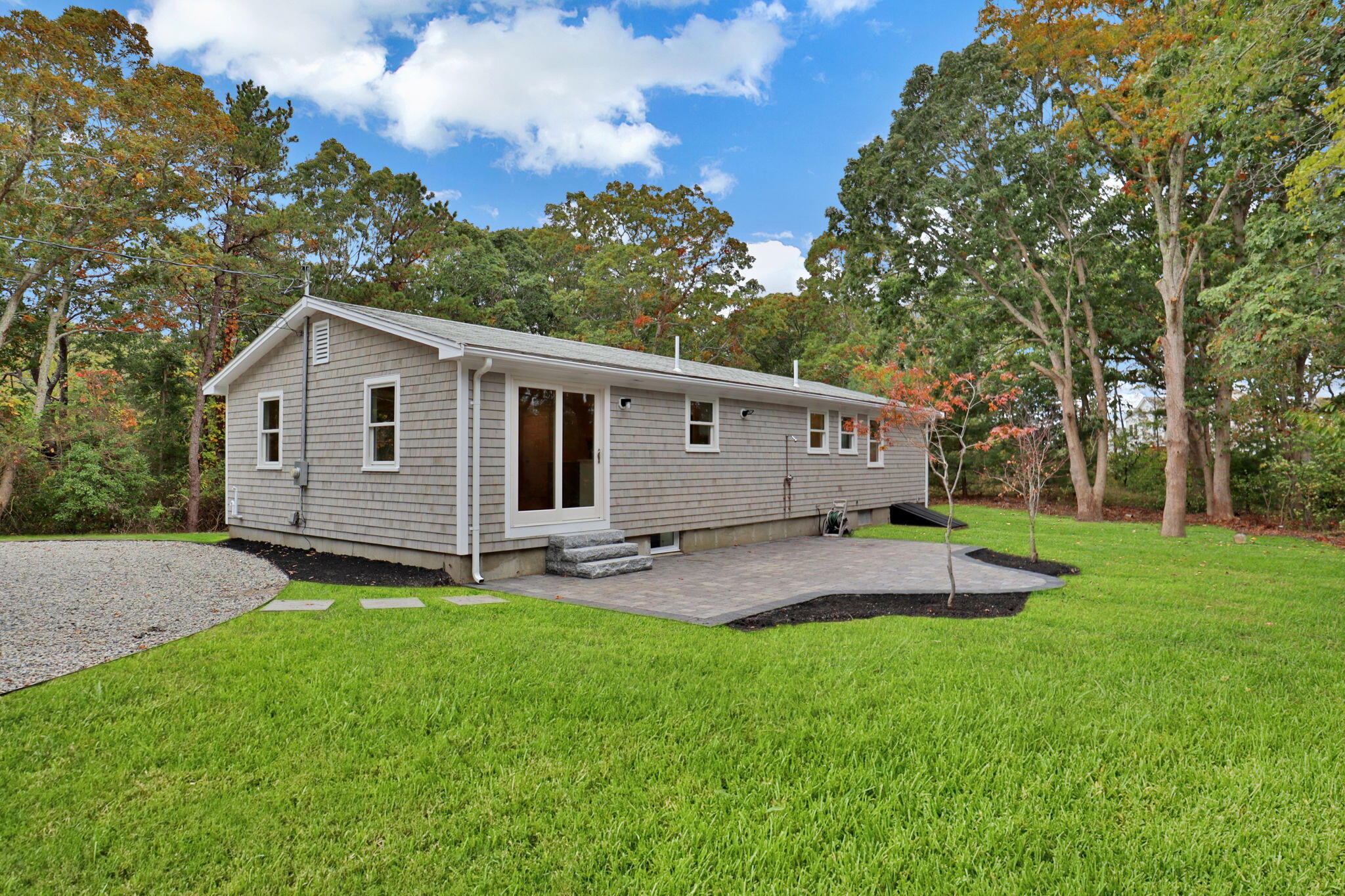 145 Stony Brook Road Brewster, MA 02631 - Photo 5 of 42 a view of a backyard with a garden