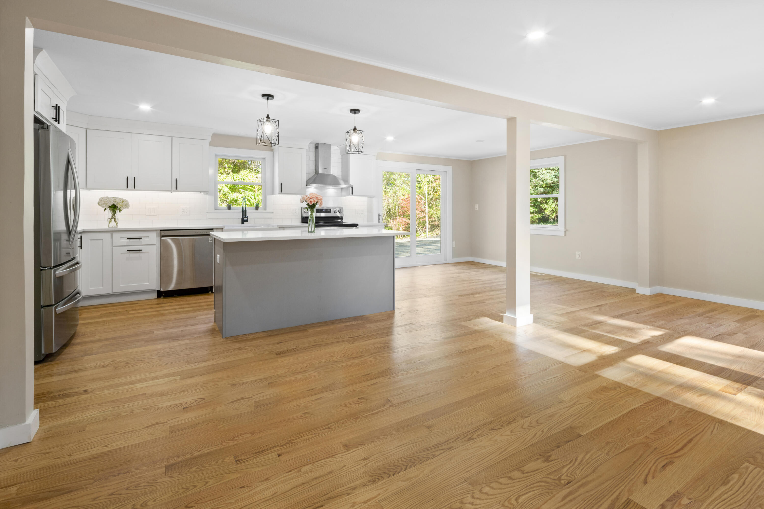 145 Stony Brook Road Brewster, MA 02631 - Photo 8 of 42 a large kitchen with cabinets wooden floor a stainless steel appliances and a dining table