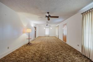 1717 Pipeline Road Cleburne, TX 76033 - Photo 12 of 26 a view of a livingroom with a ceiling fan window and wooden floor