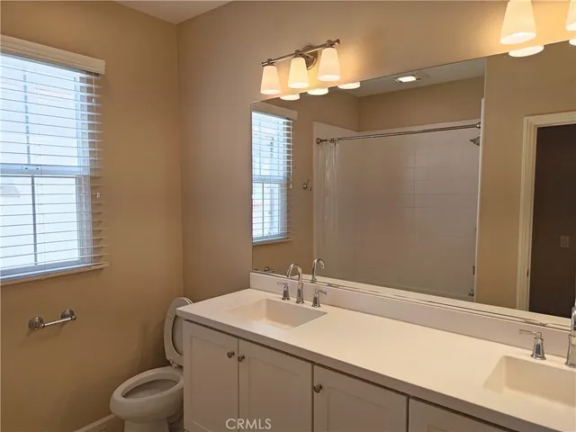 a bathroom with a sink toilet and a mirror