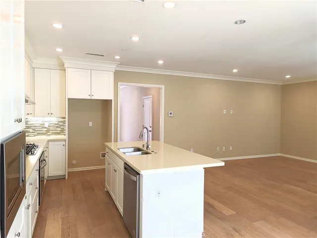 a kitchen with a refrigerator and a sink