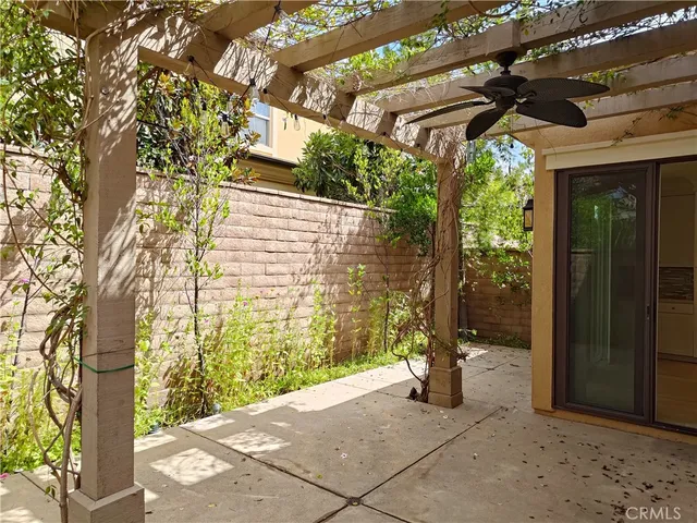 a view of patio with a table and chairs and potted plants