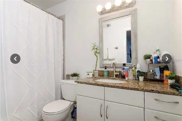 a bathroom with sink toilet and shower