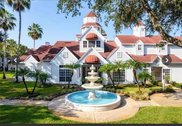 a front view of house with yard and swimming pool