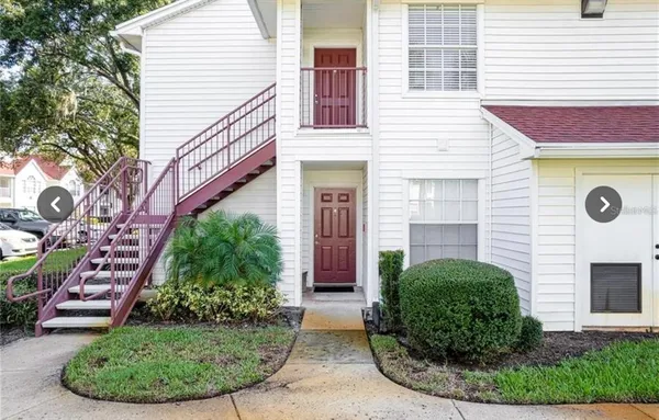 a view of a house with brick walls and a yard