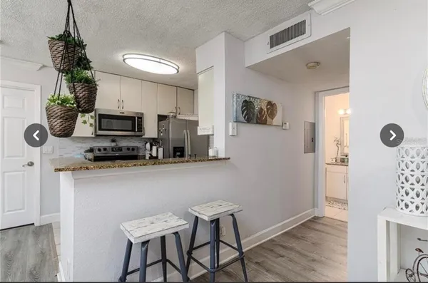 a kitchen with stainless steel appliances microwave stove refrigerator and microwave