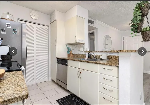 a bathroom with a granite countertop sink a mirror and a shower